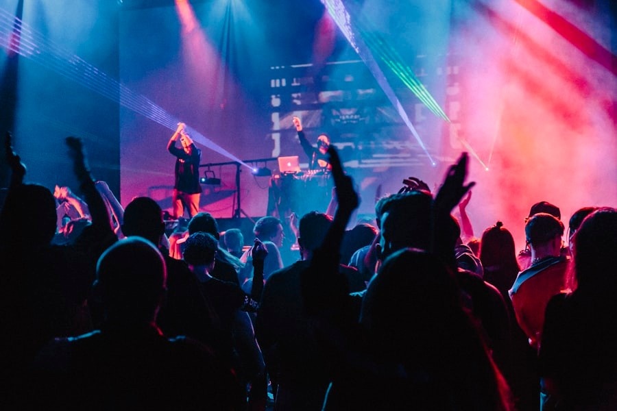 Young people dancing in a UK nightclub with neon lights