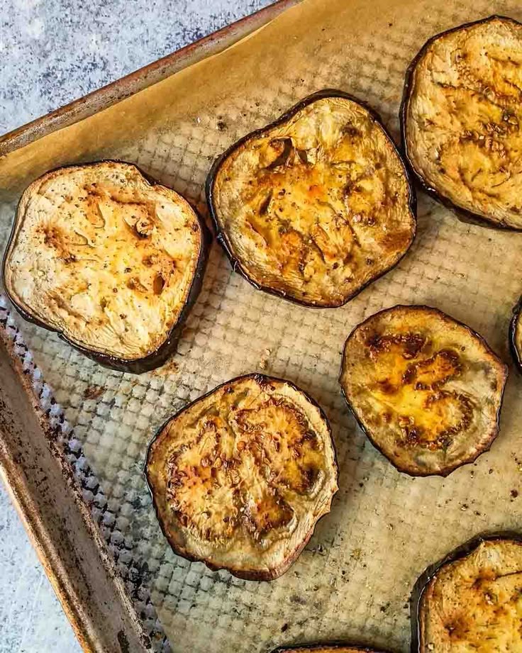 Golden roasted eggplant slices fresh out of the oven on a baking tray