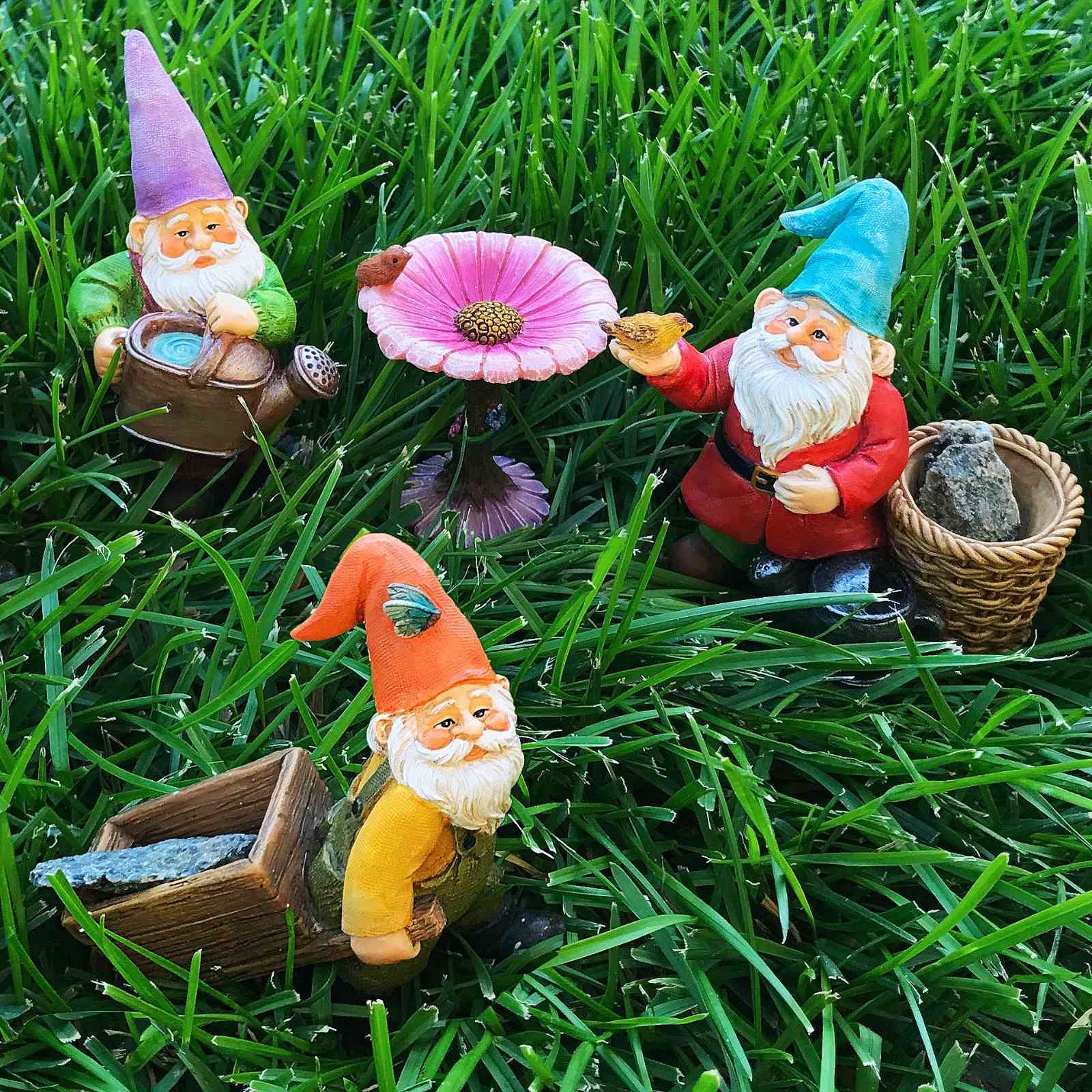 Small garden gnomes decorating a compact patio with potted plants